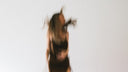 A woman dancing on a bed, caught mid-movement